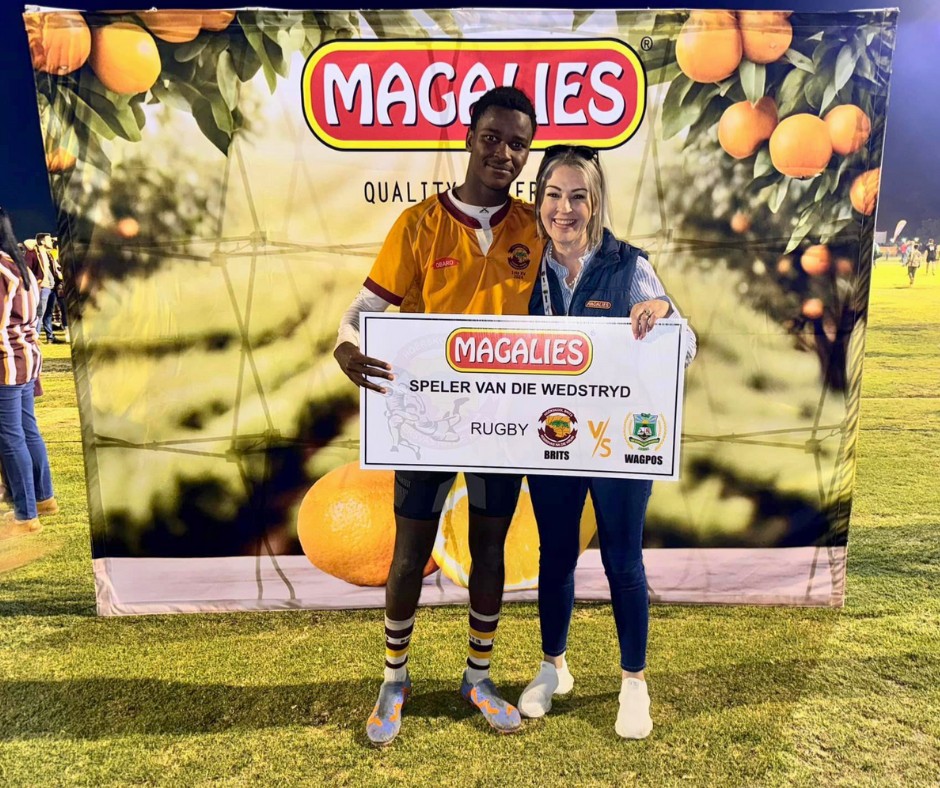 Magalies Citrus representative presenting rugby player of the match award at local community sports event